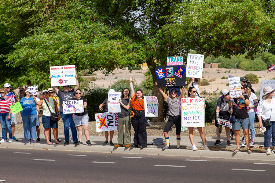 Protesters holding Trans Rights, Regime Change Starts At Home, and Super Callous Racist Sexist Nazi POTUS signs at a Goodyear Arizona rally