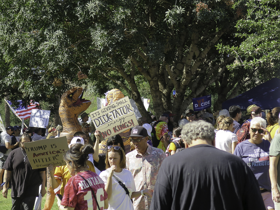 Phoenix No Kings 2.0 protest crowd with signs reading Trump is America's Hitler JD Vance quote and Its Giving Small Dick-Tator Energy