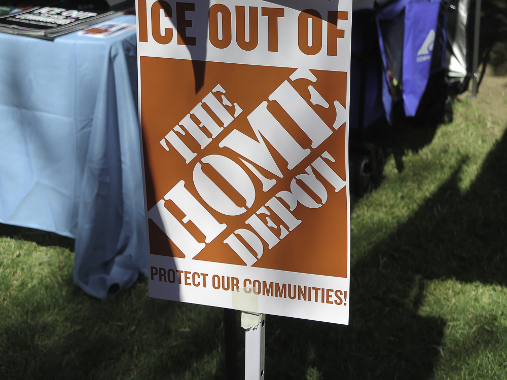 Immigration activist sign at Phoenix No Kings 2.0 protest reading ICE Out of The Home Depot Protect Our Communities