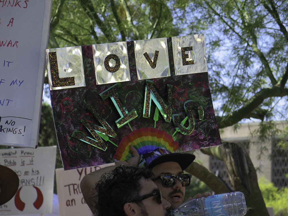 Hand-made glittering Love Wins rainbow sign held up by demonstrators at Phoenix No Kings 2.0 protest