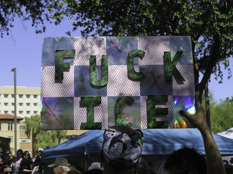 Immigration reform activist holding a creative hand-made Fuck ICE protest sign at Phoenix No Kings 2.0 rally